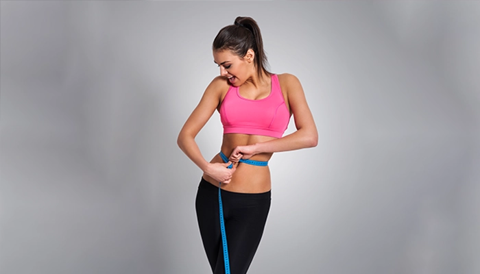 Woman Checking Body Transformation after Body Sculpting Treatment